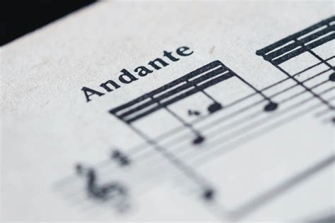 andante definition music: The Andante tempo in music is often described as a moderate pace or walking speed, which allows for a balanced and flowing melody. How does the Andante affect the emotional expression of a piece of music?